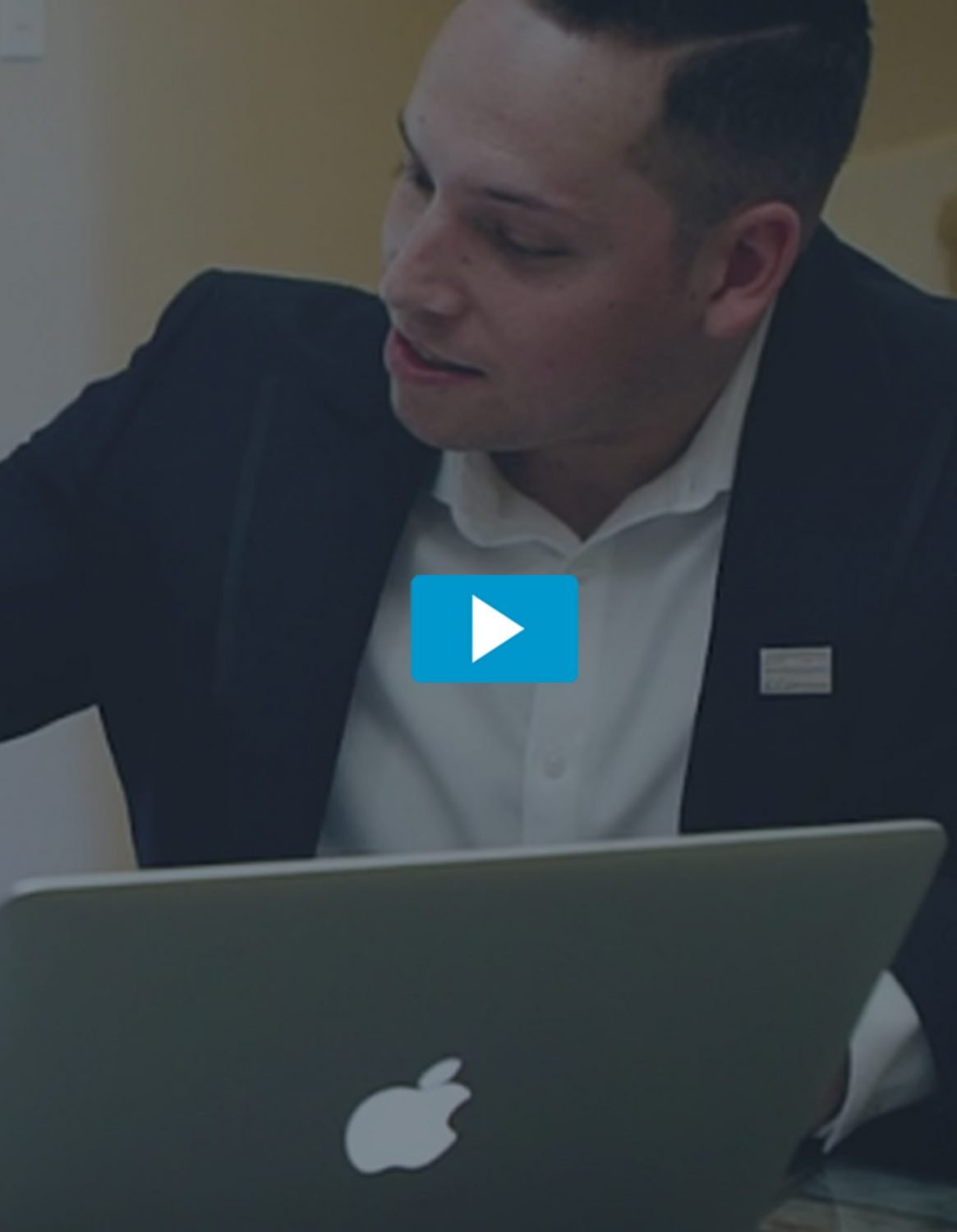 Man in suit looking at a laptop