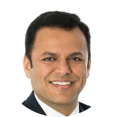 Headshot of a smiling man in a suit
